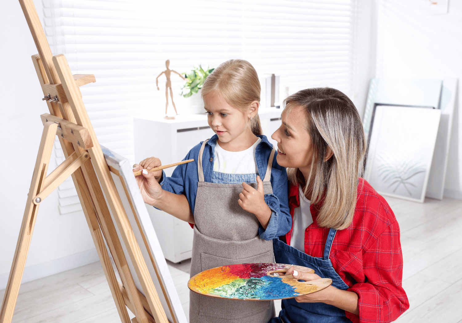 Mother and child painting at easle